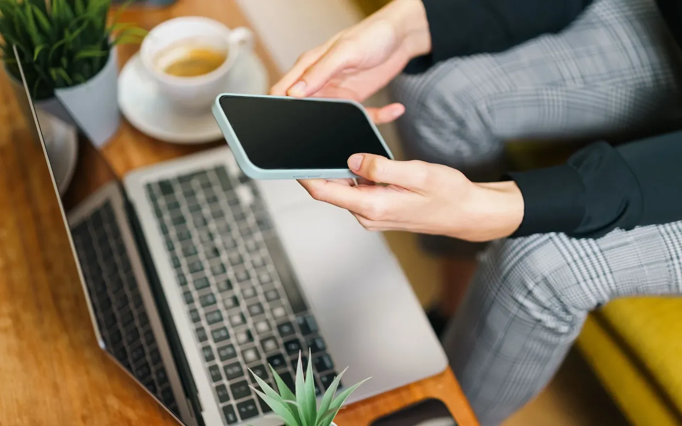 Person completing an online life insurance application on a phone and laptop